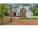 Beautiful home with attached two car garage, stone accents, and manicured landscaping at 11 Headden Nw Rdg, Cartersville, GA 30121