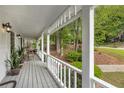 Inviting covered porch with plants and seating, perfect for enjoying the outdoors at 1519 Brookcliff Cir, Marietta, GA 30062