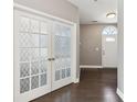 Foyer showing French doors, hardwood flooring, a gray wall color, and a white-painted front door at 3750 Thackary Dr, Powder Springs, GA 30127