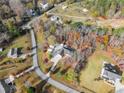 High angle shot of a home showing the front lawn, driveway, and surrounding trees at 6045 Mockingbird Rd, Cumming, GA 30028