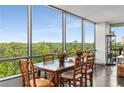 Charming dining area showcasing large windows with scenic views, a rustic wooden table, and seating for six at 700 Park Regency Ne Pl # 1407, Atlanta, GA 30326