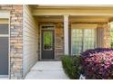 Inviting front porch with stone accents, leading to a stylish front door and charming window details at 2155 Mindy Ln, Cumming, GA 30041
