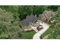 Beautiful aerial view of the home showcasing its meticulously landscaped grounds and private driveway at 2682 Boulder Creek Ne Dr, Roswell, GA 30075