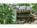 Multi-level deck overlooking a verdant backyard with a hot tub, offering ultimate outdoor enjoyment at 2682 Boulder Creek Ne Dr, Roswell, GA 30075
