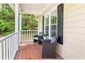 Cozy front porch features seating and decorative elements, perfect for relaxing outdoors at 411 Hollis Cir, Dallas, GA 30157