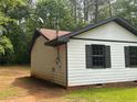 View of home showcasing white siding and updated dark trim at 595 Crowell Rd, Porterdale, GA 30014