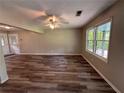 Bright living room with wood-look floors and natural light from large windows at 595 Crowell Rd, Porterdale, GA 30014