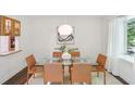 Elegant dining room with glass table, leather chairs and lots of natural light at 1410 Lively Ridge Ne Rd, Atlanta, GA 30329