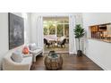 Bright and airy living room with hardwood floors and access to a screened porch at 1410 Lively Ridge Ne Rd, Atlanta, GA 30329