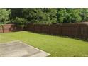 Spacious backyard with lush green grass and a privacy fence, perfect for outdoor entertaining at 1481 Park Knoll Trl, Lawrenceville, GA 30043