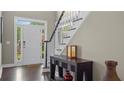 Welcoming foyer with a dark wood console table and staircase at 6209 Benbrooke Dr, Acworth, GA 30101