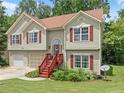 Attractive split-level home with a well-maintained lawn and landscaping, and a welcoming front entrance at 1647 Tunbridge Ln, Lawrenceville, GA 30043