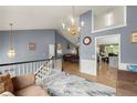 Open-concept living room features high ceilings, chandelier, and views to other living spaces at 1647 Tunbridge Ln, Lawrenceville, GA 30043