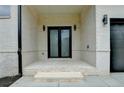 Stylish home entrance featuring a double door and modern lighting at 165 Westbrook St, Buford, GA 30518