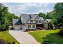 Beautiful two-story home with a three-car garage and a well-manicured lawn at 3013 Walker Hill Way, Marietta, GA 30064