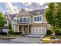 Charming home with stone accents, blue shutters, and a welcoming covered front porch at 3380 Labrouste Cv, Duluth, GA 30097
