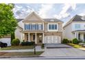 Charming home with stone accents, blue shutters, and an inviting covered front porch at 3380 Labrouste Cv, Duluth, GA 30097