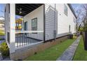 Side view of a two-story home featuring white siding and a well-maintained lawn at 962 Welch Sw St, Atlanta, GA 30310