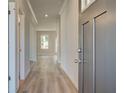 Welcoming entryway with hardwood floors, light gray walls, and modern finishes at 228 Chiswick Loop, Stockbridge, GA 30281