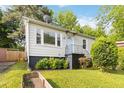 Quaint one-story house featuring a well-manicured lawn, front garden, and charming details at 286 Booker Sw St, Atlanta, GA 30315