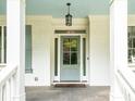 Covered front entryway with view of the glass front door, detailed trim, and blue ceiling at 4910 Conover Dr, Atlanta, GA 30338