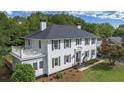Elegant two-story home with a side porch and beautifully landscaped yard featuring lovely grass and attractive shrubbery at 6104 Floyd St, Covington, GA 30014