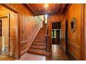 Striking foyer showcasing hardwood floors and the staircase, exuding warmth and sophistication throughout the entryway at 6104 Floyd St, Covington, GA 30014