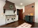 Well-appointed kitchen featuring an industrial-style stove, modern appliances, and brick accents at 6104 Floyd St, Covington, GA 30014