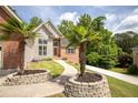 Beautiful home exterior with manicured landscaping and stone planters at 704 Willowwind Dr, Loganville, GA 30052