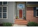 Inviting front entrance with brick steps and decorative plants by the door at 704 Willowwind Dr, Loganville, GA 30052