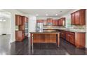 Spacious kitchen with dark wood cabinets, stainless steel appliances, granite countertops and a center island at 337 Liberty Dr, Acworth, GA 30102