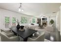 Bright, open-concept living and dining area with fireplace, hardwood floors, and access to the outdoor deck at 337 Liberty Dr, Acworth, GA 30102