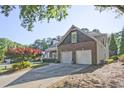 Lovely brick home with a two-car garage, driveway, and well-maintained landscaping at 12955 Mariners Ct, Alpharetta, GA 30005