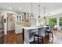 Well-lit kitchen showcasing an island with seating and modern stainless steel appliances at 4630 Carriage Walk Ln, Cumming, GA 30040