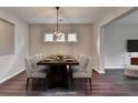 Elegant dining room featuring modern light fixture, dining table with seating for eight, and three windows at 1345 Aster Ives Dr, Lawrenceville, GA 30045