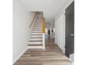 Home entryway featuring hardwood floors, stairs leading upstairs, and white neutral paint at 213 Yuba Walk, Lawrenceville, GA 30046