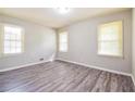 Bright bedroom featuring neutral paint, ample natural light, and luxury vinyl flooring at 3697 Wisteria Sw Ln, Atlanta, GA 30331
