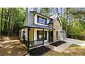 View of the exterior showing the stone facade, black trim, and front porch at 381 Fleming Ct, Jonesboro, GA 30238