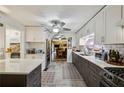 Bright kitchen featuring white cabinets, stainless steel appliances, and a stylish backsplash at 725 Brown Pl, Decatur, GA 30030