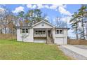 Charming home with a well-manicured lawn, garage, and inviting porch, offering great curb appeal at 1892 Buford Dam Rd, Buford, GA 30518