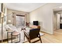 Bright living room featuring modern furniture, wood floors, and a large window showcasing the city view at 195 14Th St # 1501, Atlanta, GA 30308