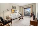 Bright living room featuring modern furniture, wood floors, and a large window showcasing the city view at 195 14Th St # 1501, Atlanta, GA 30308