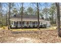Inviting single-story home with a covered front porch and well-maintained landscaping at 195 Willow Way, Stockbridge, GA 30281