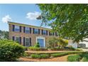 Traditional two-story brick home with blue shutters and a well-manicured front yard at 3734 Fox Hills Se Dr, Marietta, GA 30067