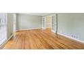 Open-concept living space with hardwood floors and white french doors at 3734 Fox Hills Se Dr, Marietta, GA 30067