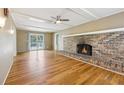 Cozy living room featuring hardwood floors and brick fireplace at 3734 Fox Hills Se Dr, Marietta, GA 30067