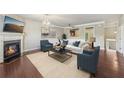 Living room area featuring hardwood floors, a fireplace, and contemporary furnishings at 1257 Park Pass Way, Suwanee, GA 30024