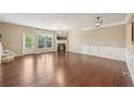 Spacious living room with hardwood floors, fireplace, large window, and crown molding at 1257 Park Pass Way, Suwanee, GA 30024