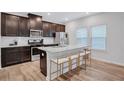 Modern kitchen with stainless steel appliances, granite countertops, and an island with barstool seating at 4658 Electric Sw Ave, Mableton, GA 30126
