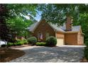 Brick home featuring an attached garage, well-maintained lawn and an American flag at 1187 Ward Creek Sw Dr, Marietta, GA 30064